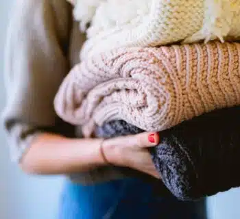 person holding knitted textiles