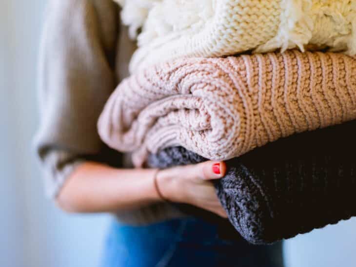 person holding knitted textiles
