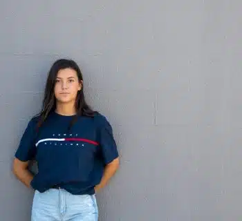 woman standing while leaning on wall