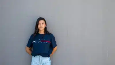 woman standing while leaning on wall