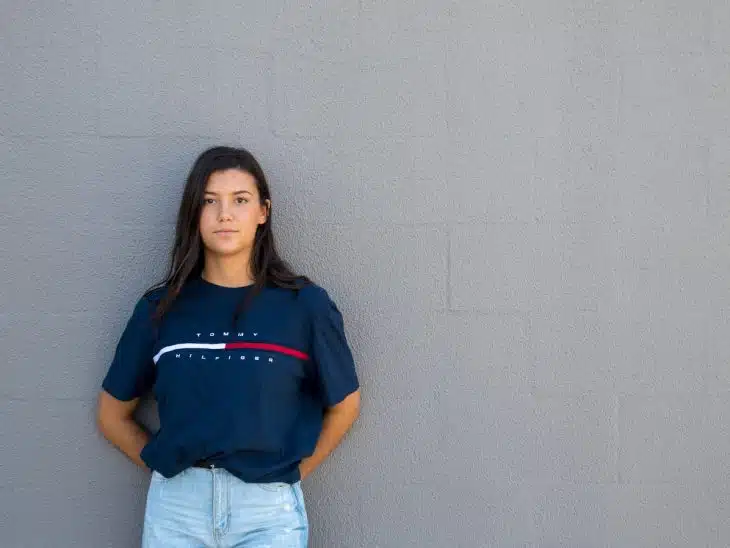 woman standing while leaning on wall